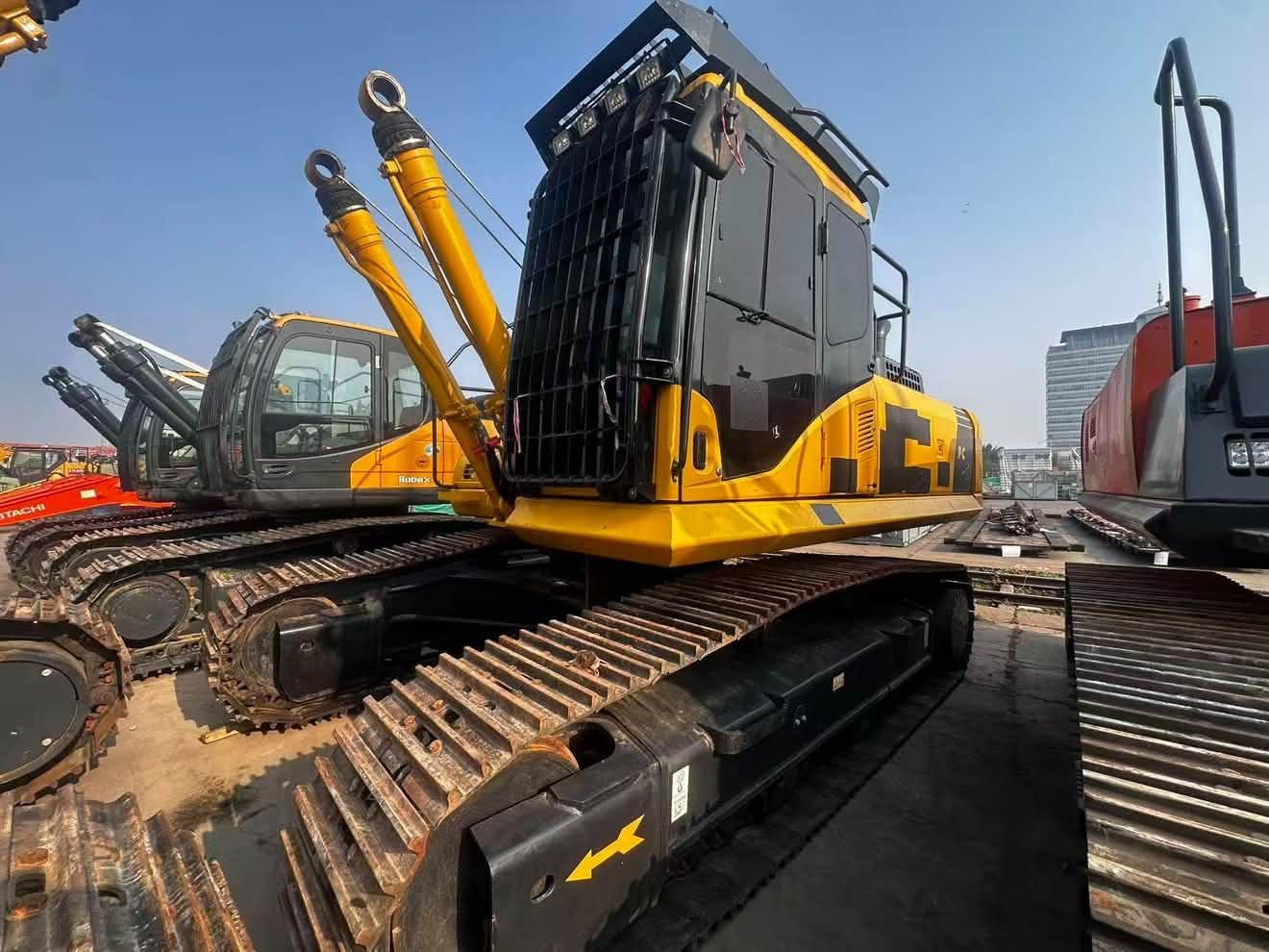 Yellow crawler excavator in a machinery yard